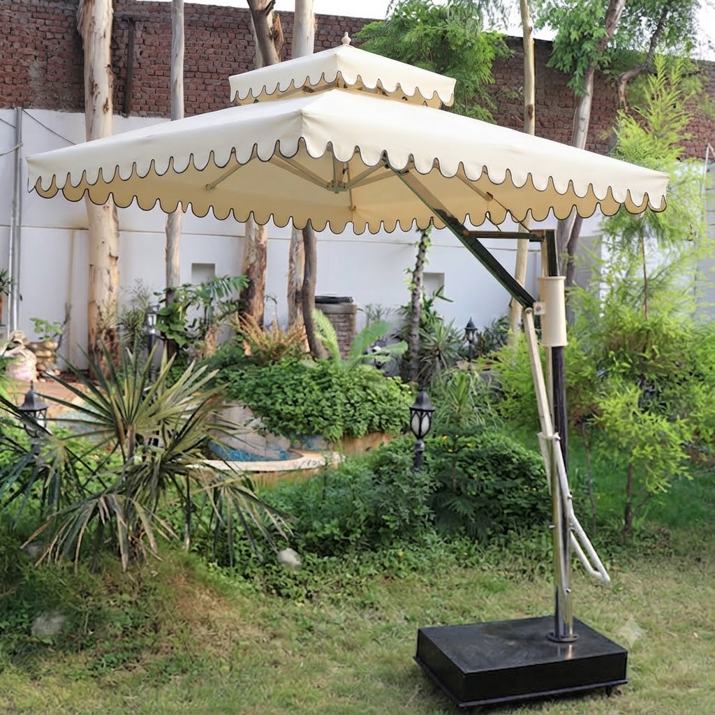 A large beige patio umbrella with a scalloped edge and black base, shown outdoors in a garden setting.