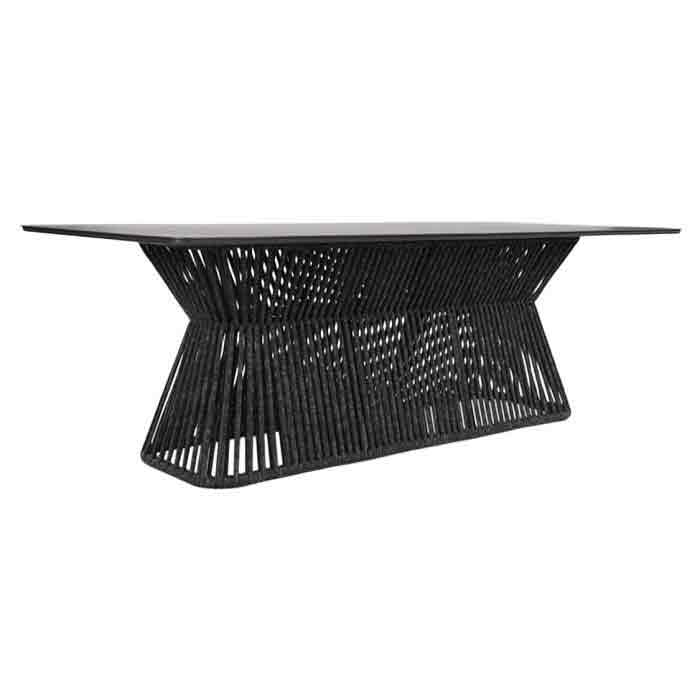 A modern black dining table with a flat rectangular top and a sculptural, woven geometric base, shown against a plain white background.