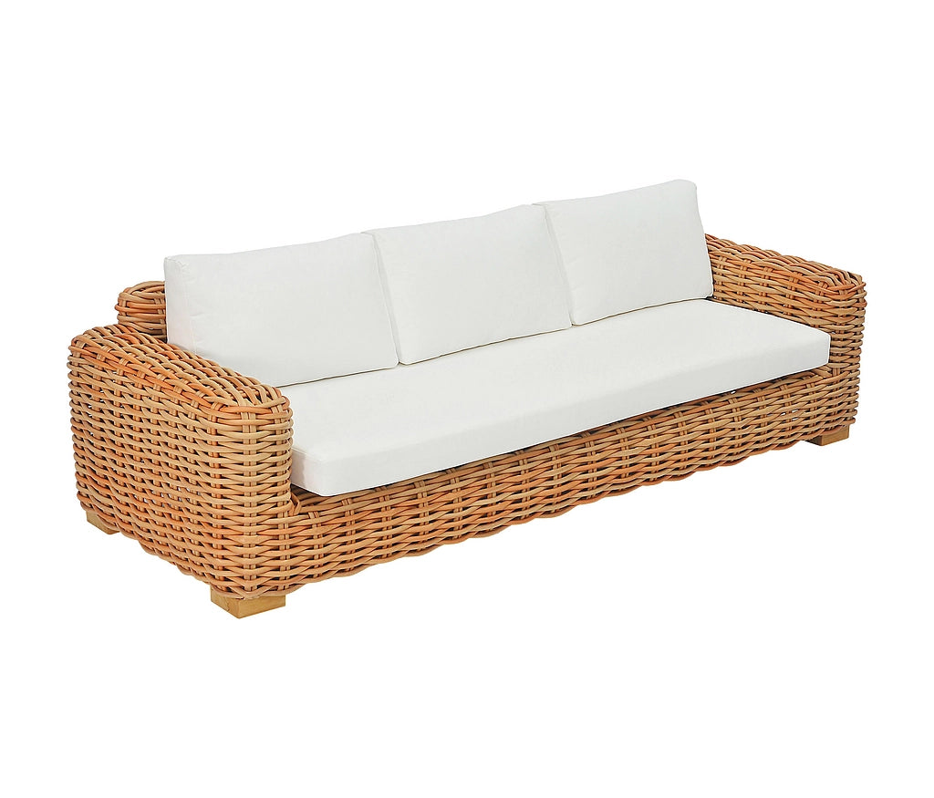 A three-seat outdoor sofa with a natural woven wicker frame and thick white cushions, shown on a plain white background.