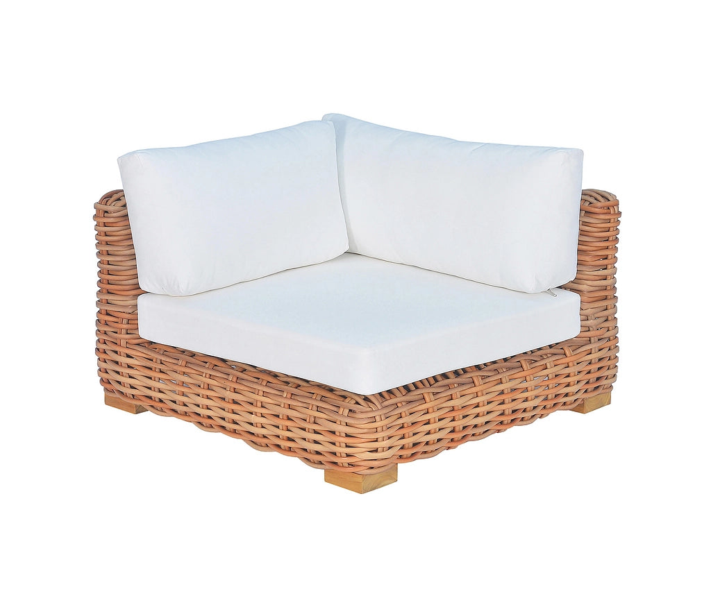 A corner outdoor armchair with a natural woven wicker frame and thick white cushions, shown against a plain white background.